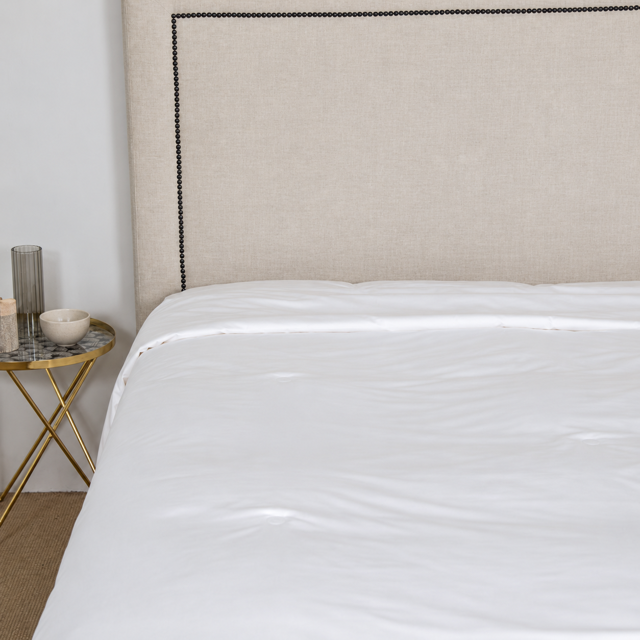 White silk duvet insert laid smoothly across a bed