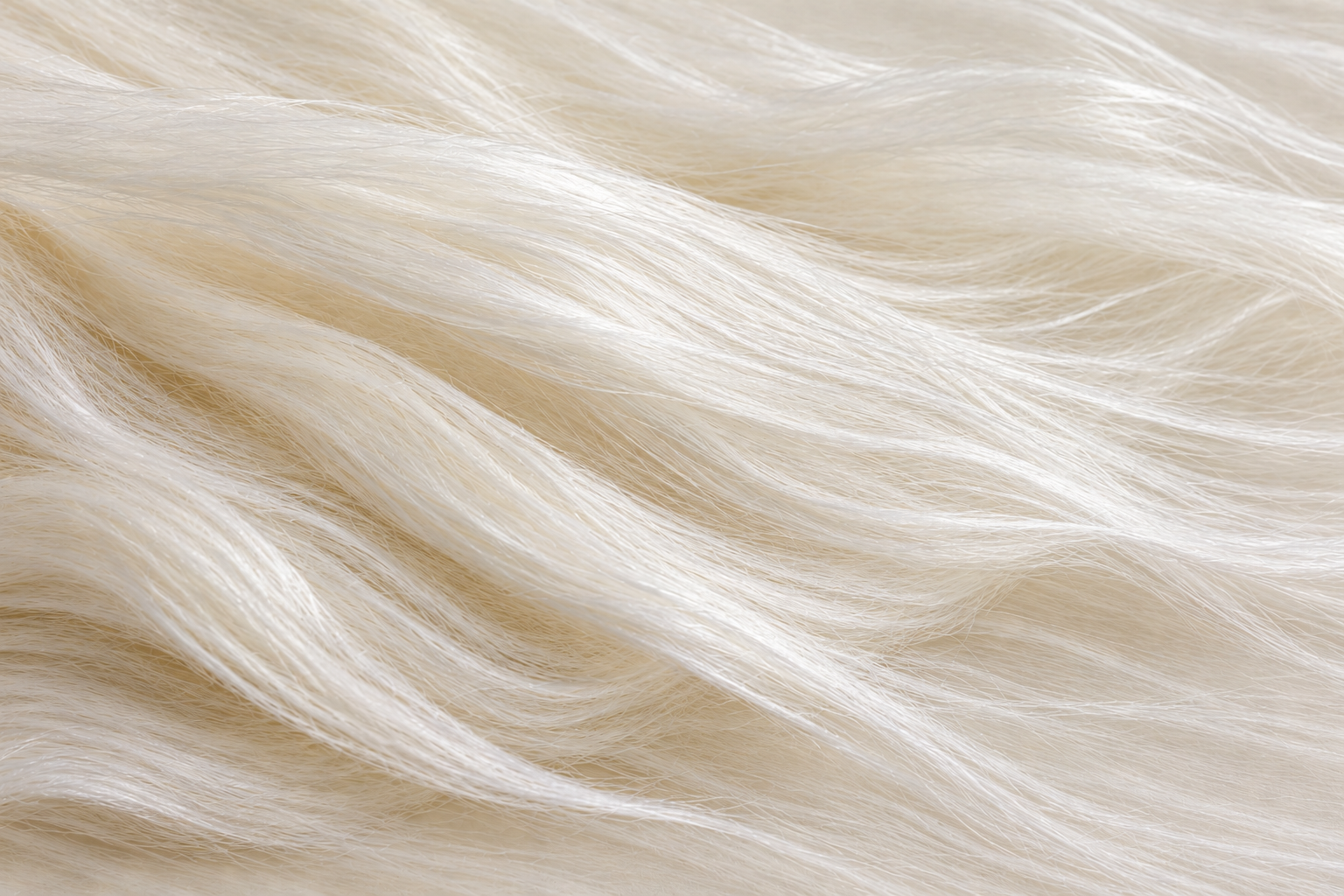 Close-up material illustration of long, continuous mulberry silk filaments extending across the frame